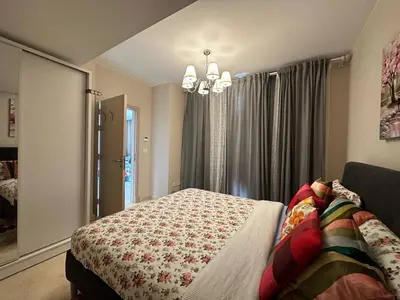 a bedroom with a bed and a chandelier at Mangroovy Tasteful 1 bedroom in Hurghada