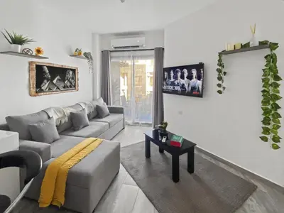 a living room with a couch and a table at 3BR 2BA Retreat with Four Pools Gym and Onsite Dining Close to El Gouna in Hurghada