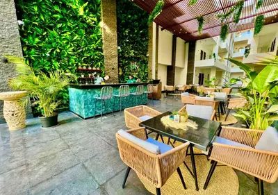 a restaurant with a table and chairs and a bar at 3BR 2BA Retreat with Four Pools Gym and Onsite Dining Close to El Gouna in Hurghada