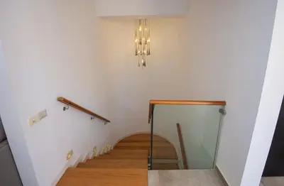 a hallway with a staircase with a chandelier and a mirror at Soma Bay Seafront Luxury Appartement in Hurghada