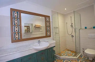 a bathroom with a sink and a shower and a mirror at Soma Bay Seafront Luxury Appartement in Hurghada