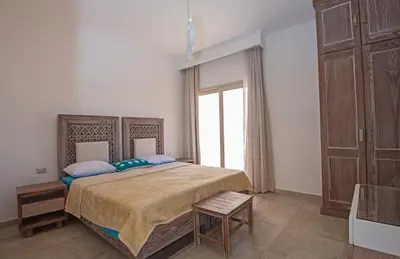 a bedroom with a large bed and a large window at Soma Bay Seafront Luxury Appartement in Hurghada