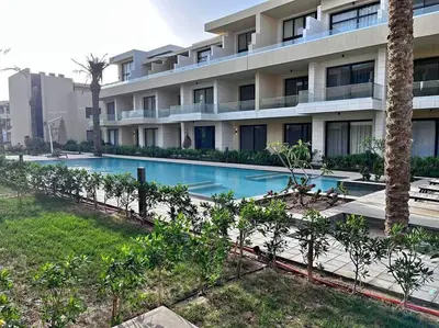 a building with a swimming pool in front of a building at Brand new studio at G-Cribs ElGouna in Hurghada
