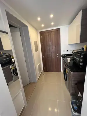 a kitchen with a hallway with a door to a room at Brand new studio at G-Cribs ElGouna in Hurghada