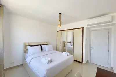 a bedroom with a bed with two towels on it at Refreshed & Uplifted 2 BDR G Cribs in Hurghada