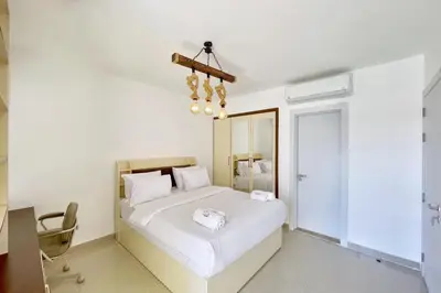 a bedroom with a white bed and a chandelier at Refreshed & Uplifted 2 BDR G Cribs in Hurghada