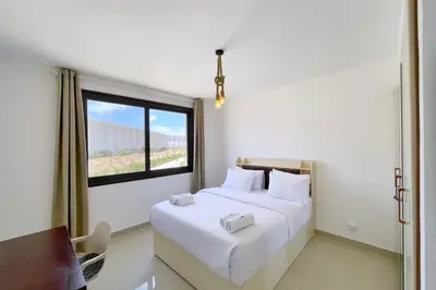a bedroom with a large white bed with a window at Refreshed & Uplifted 2 BDR G Cribs in Hurghada