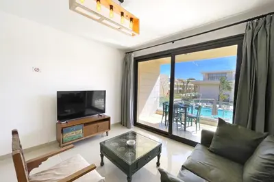 a living room with a couch and a television at Refreshed & Uplifted 2 BDR G Cribs in Hurghada