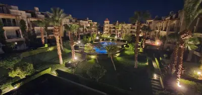 an aerial view of a courtyard with palm trees and buildings at veranda sahl hasheesh resort in Hurghada