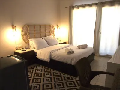 a bedroom with a large bed with a wooden headboard at Aldau heights Kevin in Hurghada