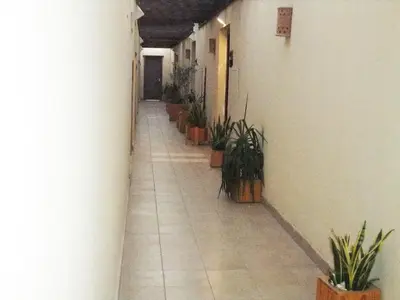 a hallway with potted plants on the side of a building at Aldau heights Kevin in Hurghada