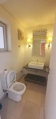 a bathroom with a toilet and a sink and a mirror at veranda sahl hasheesh resort studio in Hurghada