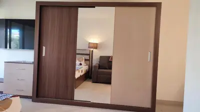 a large mirror in a room with a bedroom at veranda sahl hasheesh resort studio in Hurghada