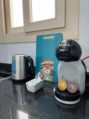 a coffee maker sitting on a counter next to a box at BS Lodging 15 - Next to Dream Beach in Hurghada