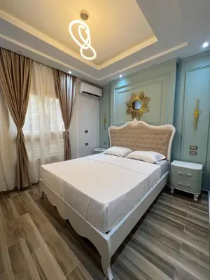 a bedroom with a large white bed in a room at BS Lodging 15 - Next to Dream Beach in Hurghada