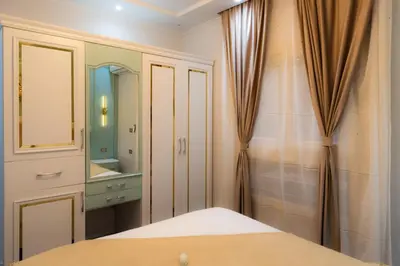 a bedroom with a bed and a mirror at BS Lodging 15 - Next to Dream Beach in Hurghada