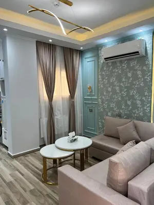 a living room with a couch and a table at BS Lodging 15 - Next to Dream Beach in Hurghada