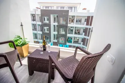a table and chairs on a balcony with a window at 2 Bed Resort Apt-Sleeps 4-Balcony-Hotel Services in Hurghada