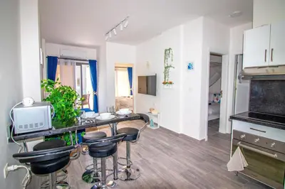 a kitchen with a counter and stools in a room at 2 Bed Resort Apartment - Sleeps 4 - Hotel Services in Hurghada