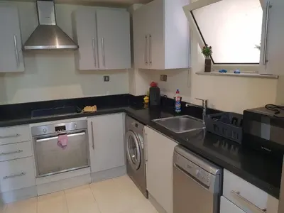 a kitchen with a sink and a dishwasher at شقه غرفتين وصاله بالحديقه في فراندا سهل حشيش in Hurghada