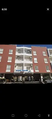 a view of a building with an airplane flying over it at One bedroom apartment in Aqua palm resort before Al Gouna in Hurghada
