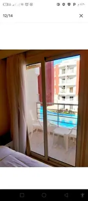 a view of a balcony from a bedroom with a window at One bedroom apartment in Aqua palm resort before Al Gouna in Hurghada