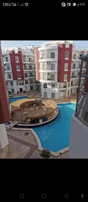 a view of a large apartment complex with a swimming pool at One bedroom apartment in Aqua palm resort before Al Gouna in Hurghada