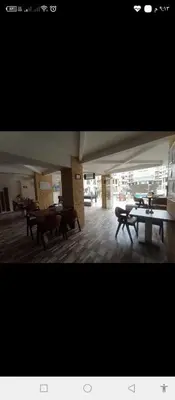 a room with tables and benches in a building at One bedroom apartment in Aqua palm resort before Al Gouna in Hurghada