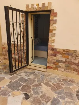 a door that is open to a room with a bed at Abeer Suites 3 basement in Hurghada