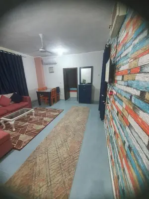 a living room with a wall with a painting on it at Abeer Suites 3 basement in Hurghada