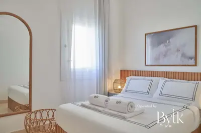 a white bedroom with a bed with towels on it at BYTK - La Veranda in Hurghada