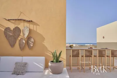 a living room with a couch and a table with butterflies on the wall at BYTK - La Veranda in Hurghada