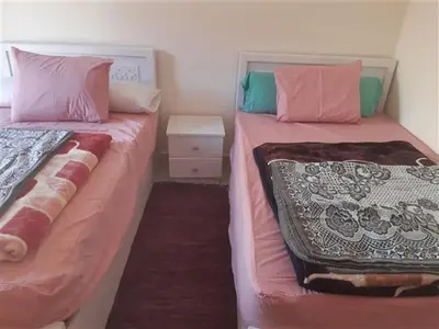 two beds sitting next to each other in a room at Chalet in Casablanca Beach Resort in Hurghada
