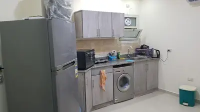 a kitchen with a refrigerator and a washing machine at Chalet in Casablanca Beach Resort in Hurghada