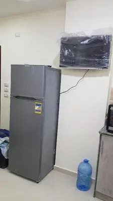 a small refrigerator in a corner of a room at Chalet in Casablanca Beach Resort in Hurghada
