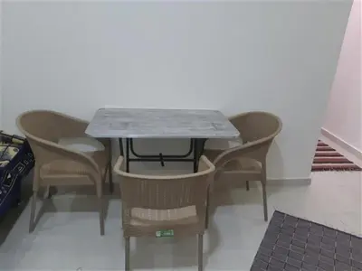 a table with four chairs and a marble top at Chalet in Casablanca Beach Resort in Hurghada
