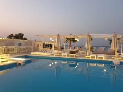 a large swimming pool with chairs and umbrellas at Amazing 2 bedroom Selena Bay Hurghada in Hurghada