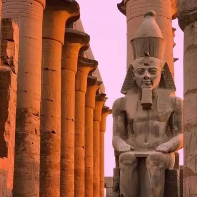 a statue in front of a building with columns at Nile Cruise Aswan & Luxor & Abu Simbel in Luxor