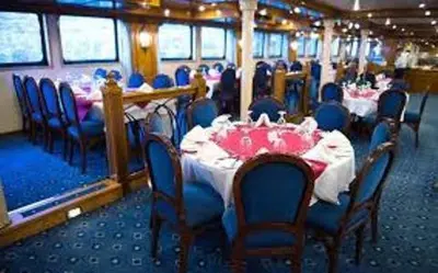 a dining car on a train with tables and chairs at Nile Cruise Aswan & Luxor & Abu Simbel in Luxor