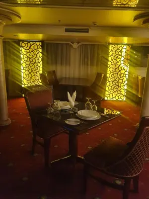 a table with plates on it in a room at Nile Cruise Aswan & Luxor & Abu Simbel in Luxor