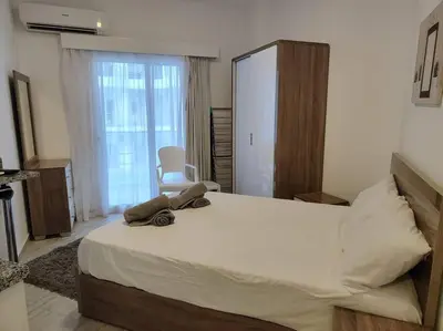 a bedroom with a large bed and a large window at A Superb Studio Apartment in Hurghada