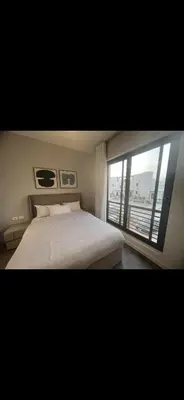 a bedroom with a bed and a large window at El Gouna 3 bedroom Penthouse Cyan in Hurghada