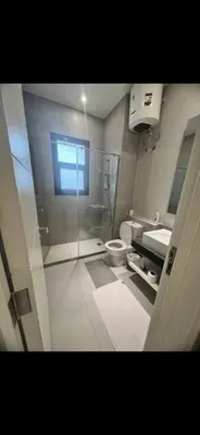 a bathroom with a shower and a toilet and a sink at El Gouna 3 bedroom Penthouse Cyan in Hurghada