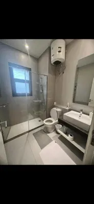 a bathroom with a shower toilet and a sink at El Gouna 3 bedroom Penthouse Cyan in Hurghada