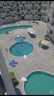 an overhead view of a pool with chairs and water at ستوديو كومباوند طيبة فيو in Hurghada