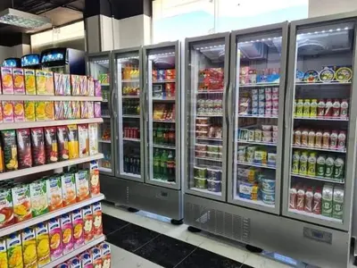 a grocery store aisle with refrigerators and drinks at ستوديو كومباوند طيبة فيو in Hurghada