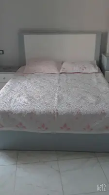 a bed with pink flowers on it in a room at ستوديو كومباوند طيبة فيو in Hurghada