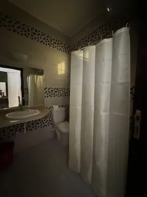 a bathroom with a toilet and a sink at Уютное место рядом с променадом in Hurghada