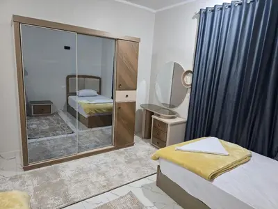 a bedroom with a mirror and a bed and a sink at Moon Adam hostel in ‘Ezbet Abu Ḥabashi