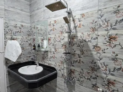 a bathroom with a sink and flowers on the wall at Moon Adam hostel in ‘Ezbet Abu Ḥabashi